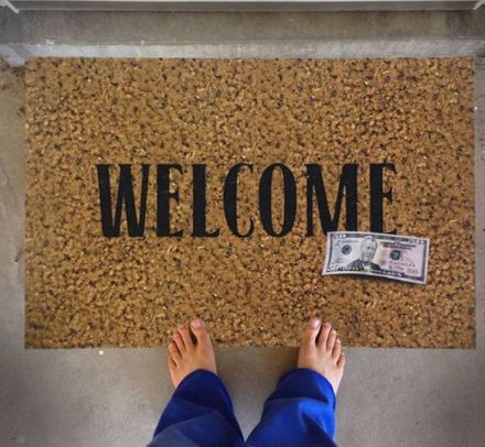 Welcome Door Mat With a Fake 50 Dollar Bill On It