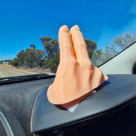 This 2-Finger Waving Hand Mounts To Your Dashboard, Never Miss Another Wave Again