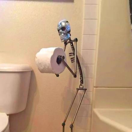 This Creepy Metal Skeleton Toilet Paper Holder Is Perfect For Horror Lovers