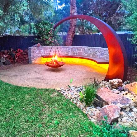 This Hanging Fire Pit Is Held Up With A Giant Arching Metal Beam