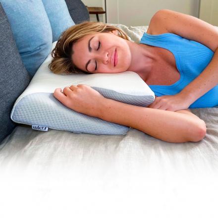 This Ergonomic Pillow Has Arm Slots Designed For Side and Stomach Sleepers