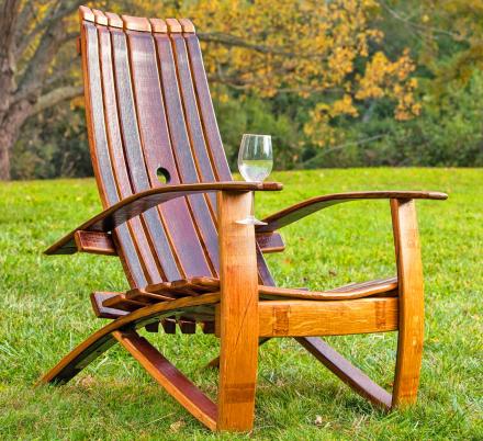 This Adirondack Chair Is Made From an Old Wine Barrel and Has a Slot For a Wine Glass