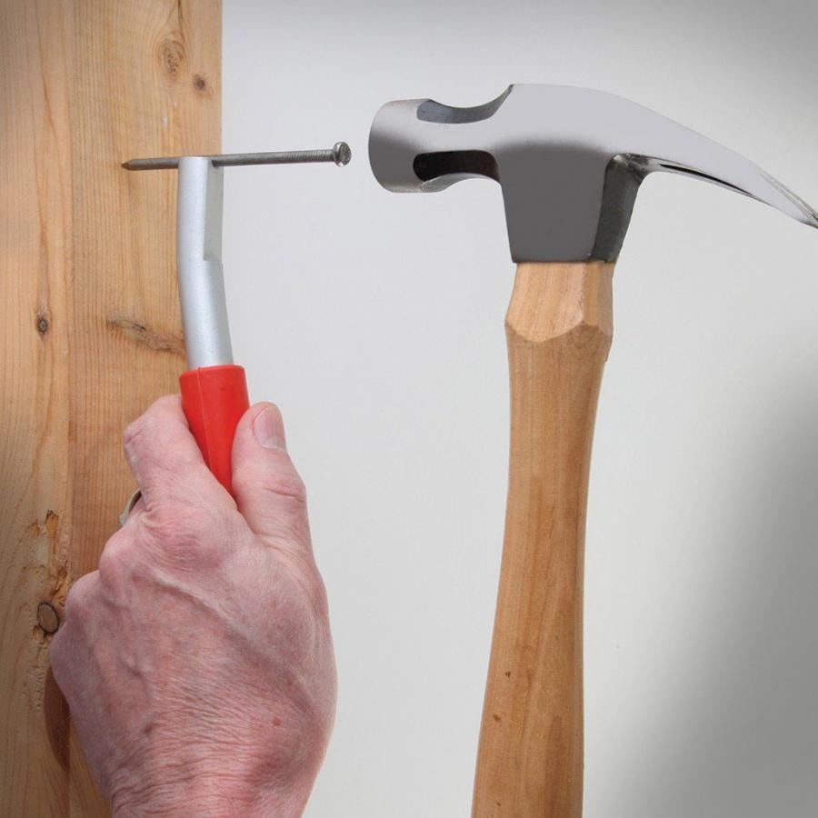 A young person prepares to use a hammer and nail Royalty-Free Stock Image -  Storyblocks