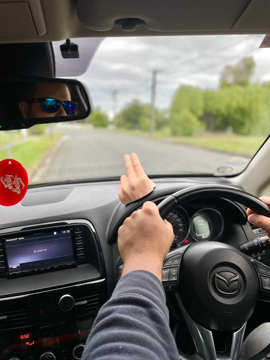 This 2-Finger Waving Hand Mounts To Your Dashboard, Never Miss