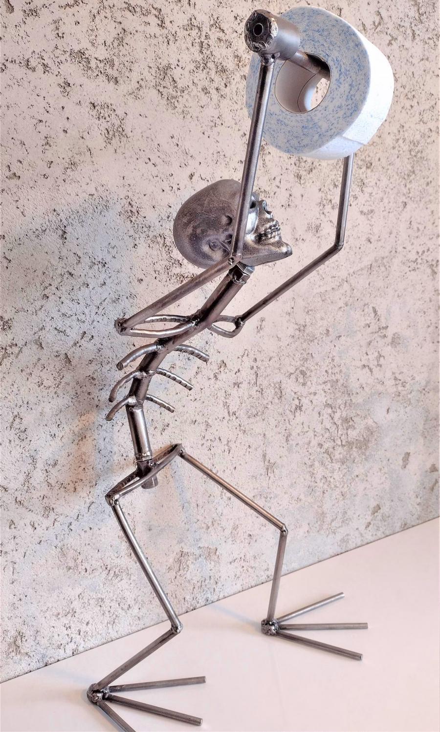 This Creepy Metal Skeleton Toilet Paper Holder Is Perfect For