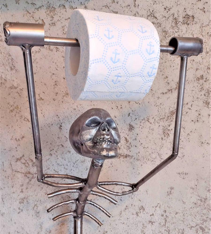 This Creepy Metal Skeleton Toilet Paper Holder Is Perfect For Horror Lovers