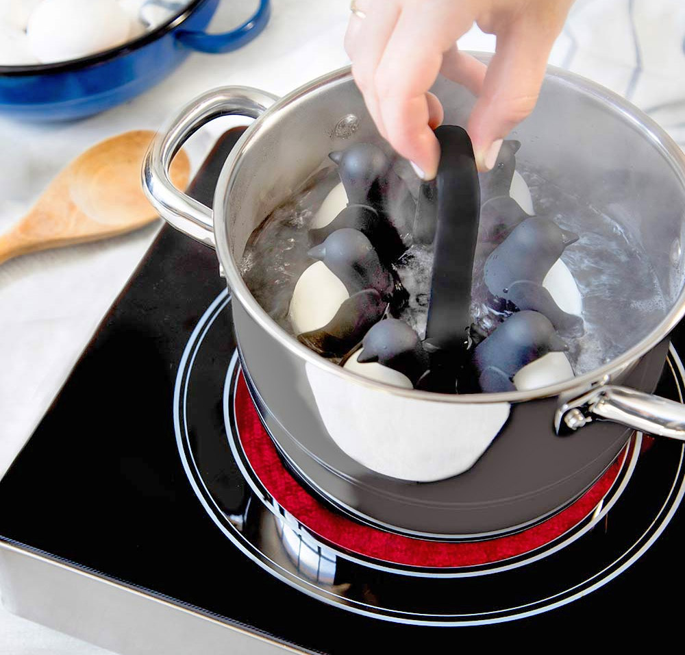 Egguins Penguin egg holders hold eggs under boiling water - penguin shaped egg server