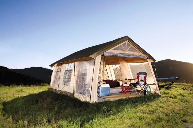 This Giant House Shaped Tent With a Front Porch Fits Up To 10 People