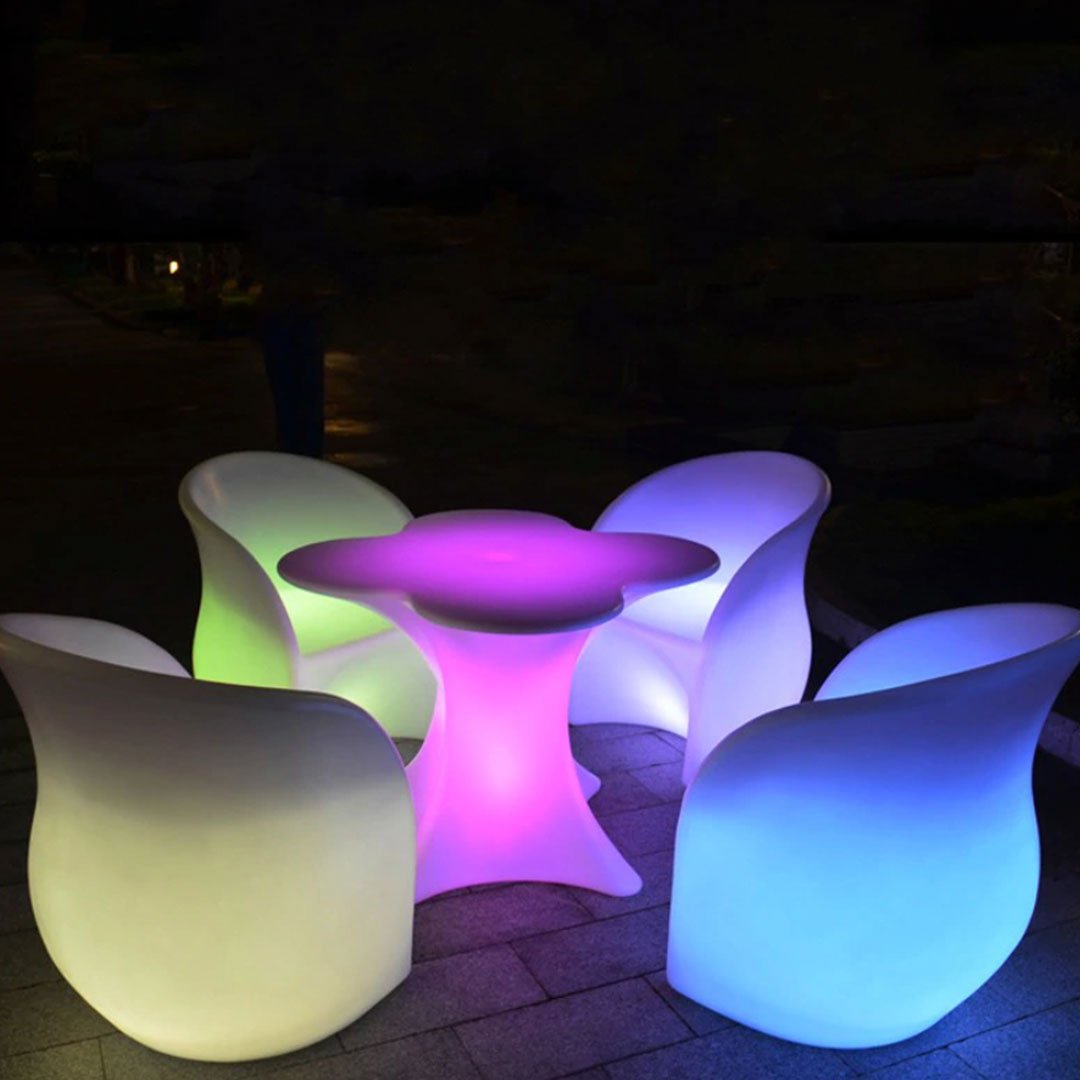Illuminating outdoor poolside table and chairs