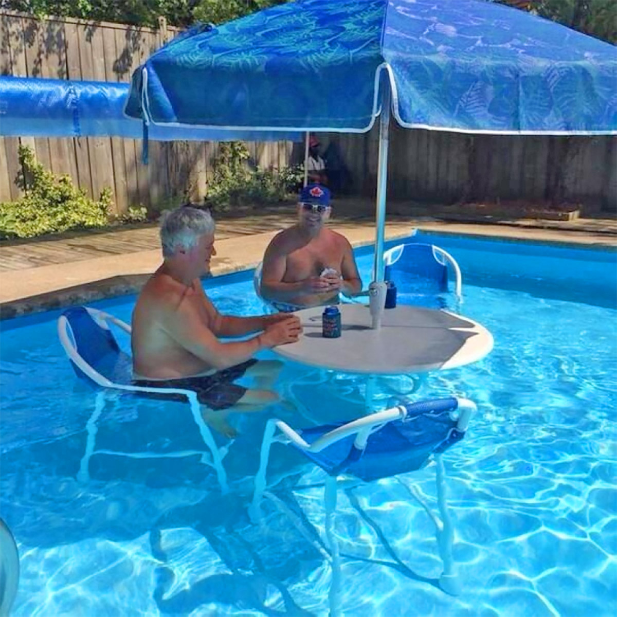 swimming pool table set with umbrella