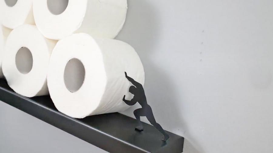 https://odditymall.com/includes/content/upload/leaning-toilet-paper-shelf-with-strong-man-holding-up-rolls-7504.jpg