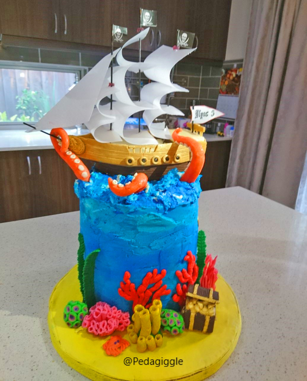 Extravagant pirate ship birthday cake that's being attacked by a giant octopus