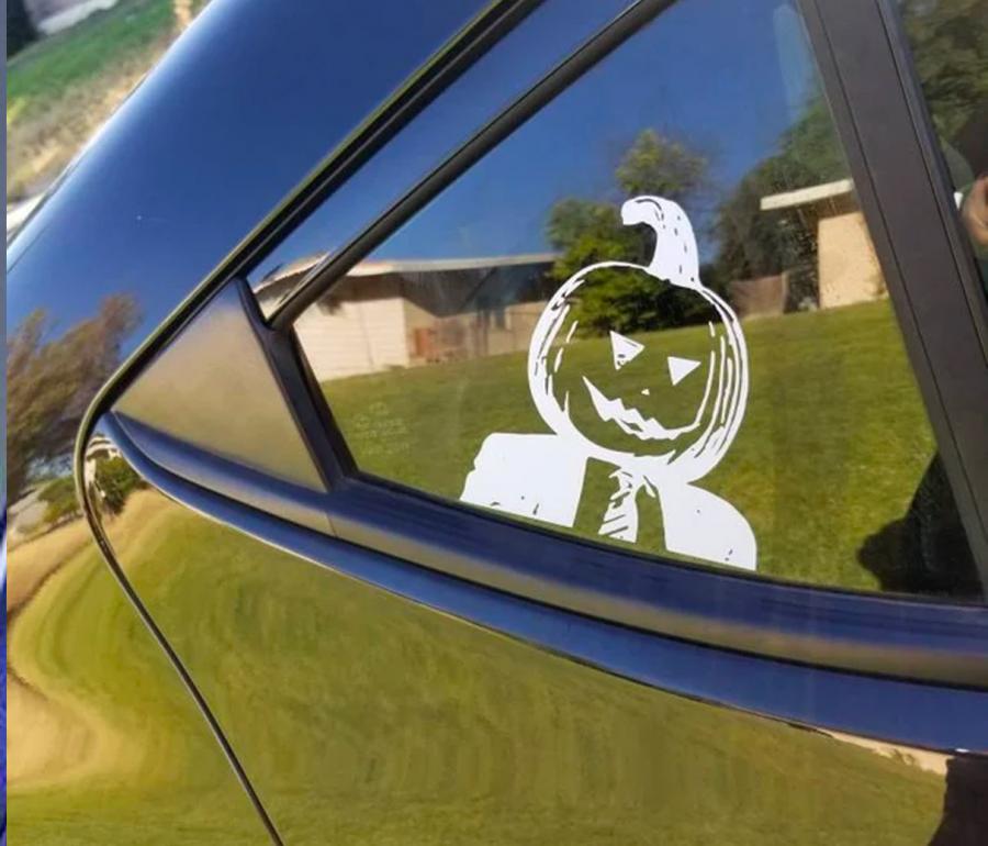 Dwight with his head inside a pumpkin car decal