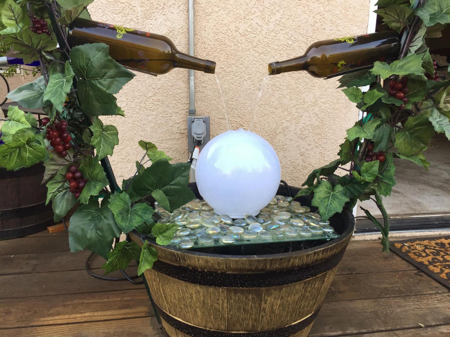 https://odditymall.com/includes/content/upload/these-plans-let-you-build-your-own-backyard-wine-bottle-fountain-5149.jpg