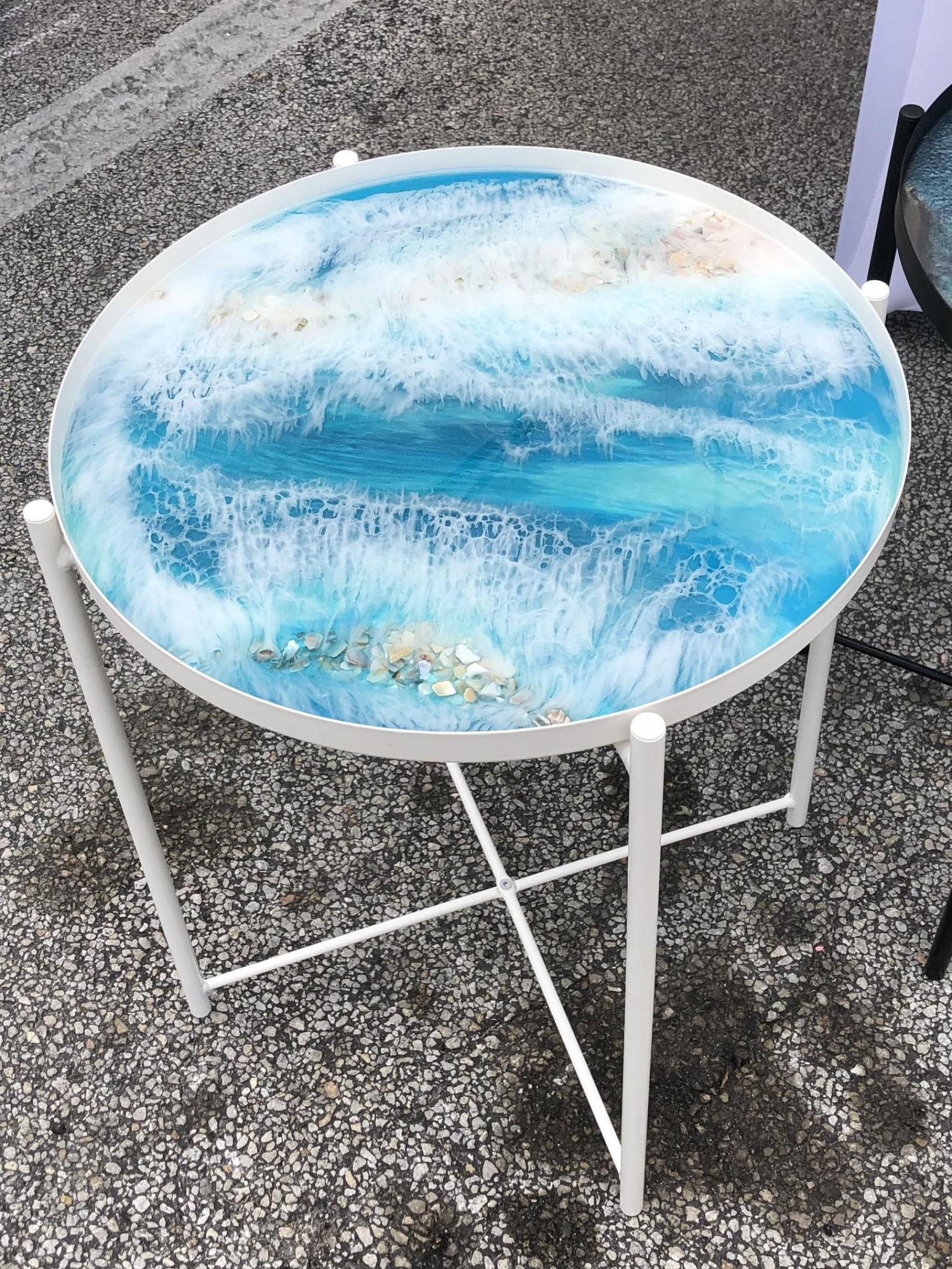 small circular epoxy table is made to look like a piece of art with beautiful ocean waves small circular epoxy table is made to look like a piece of art with beautiful ocean waves