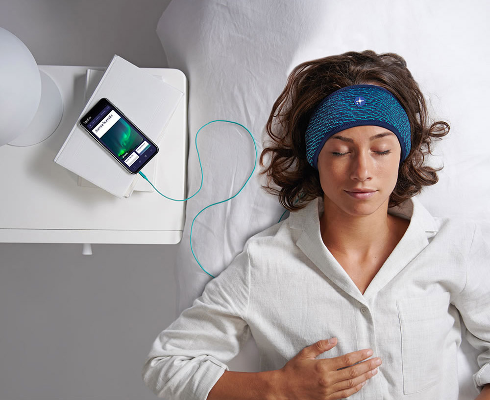 Immersive Content Sleep Headband that has built-in speakers which play sleep-inducing stories developed by relaxation, meditation, and hypnotherapy experts