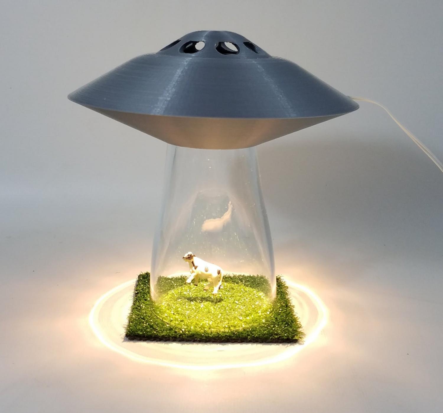 This UFO Lamp Makes It Look Like Aliens are Abducting a Cow, People