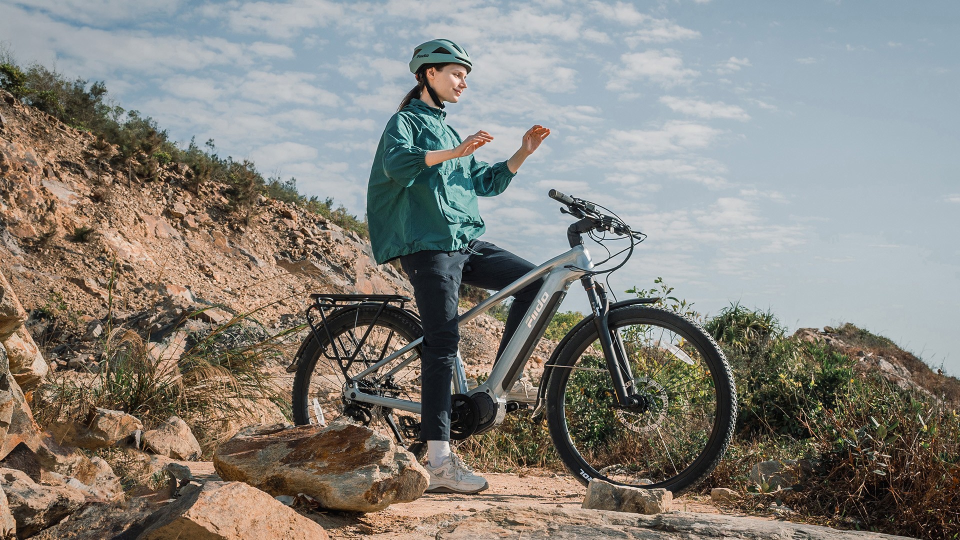 Electric bike rider stopped on a rocky outdoor trail