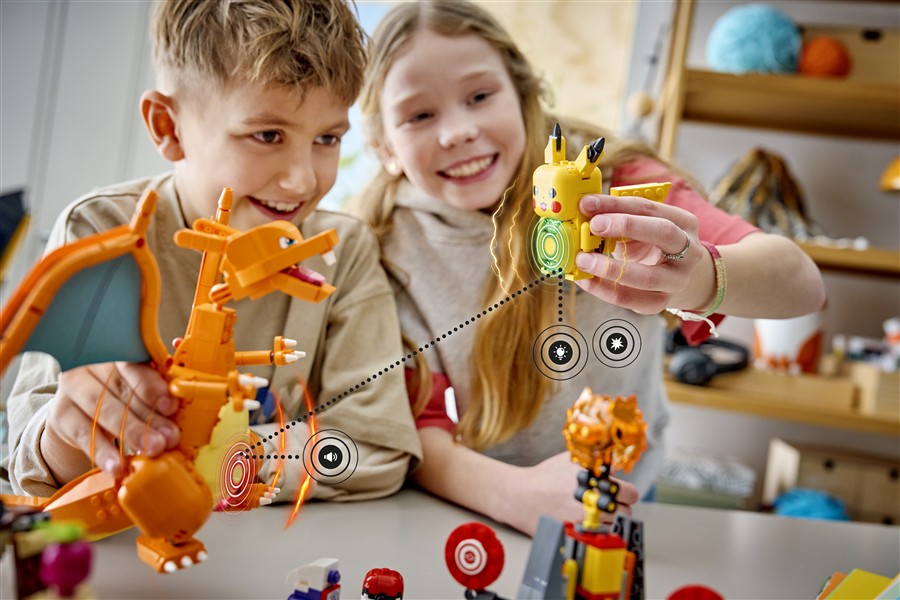 Kids playing with brick-built Charizard and SMART Play target pieces