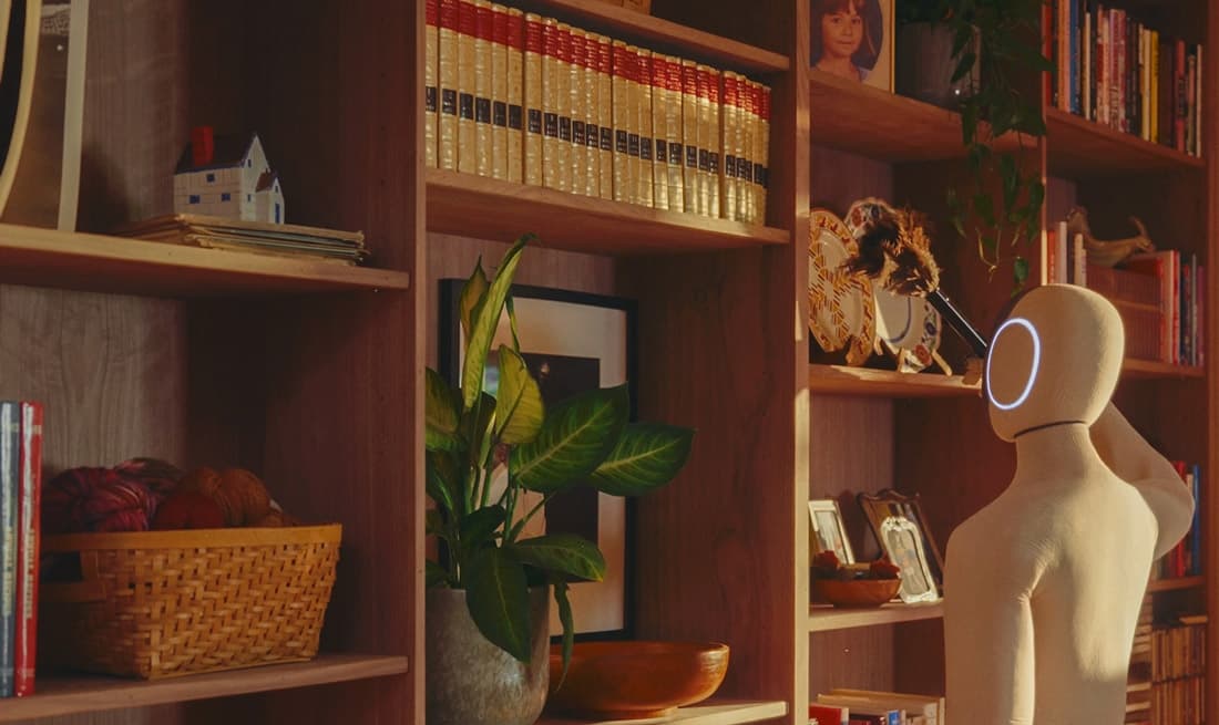 NEO humanoid robot reaching near a bookshelf
