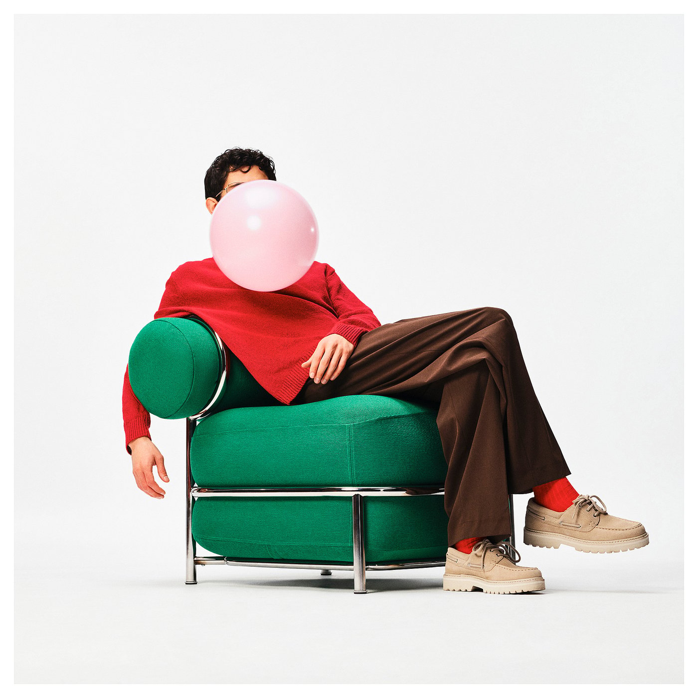 Person relaxing in the green IKEA PS 2026 inflatable armchair