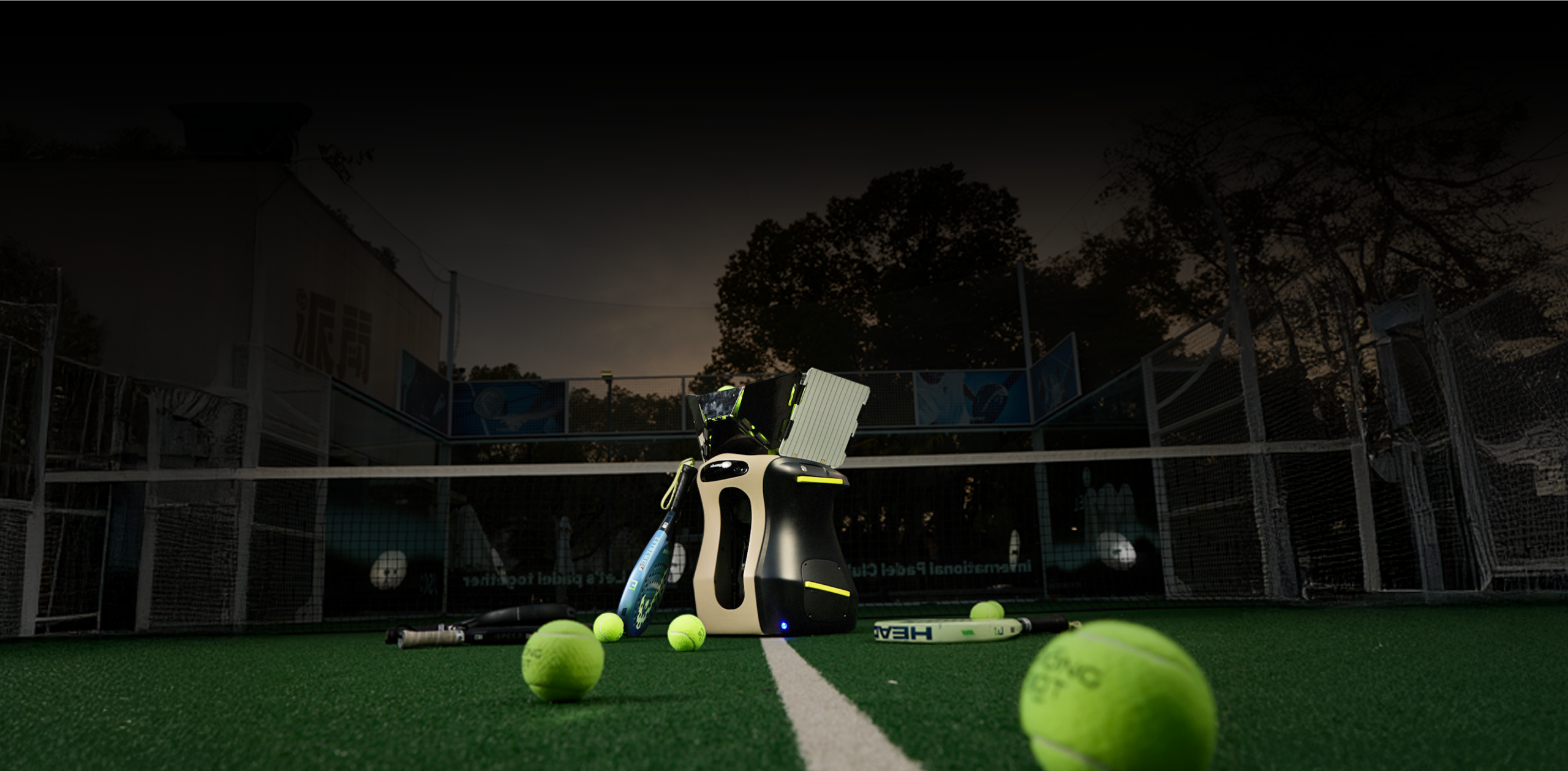 PongBot Aura on a court at night with balls