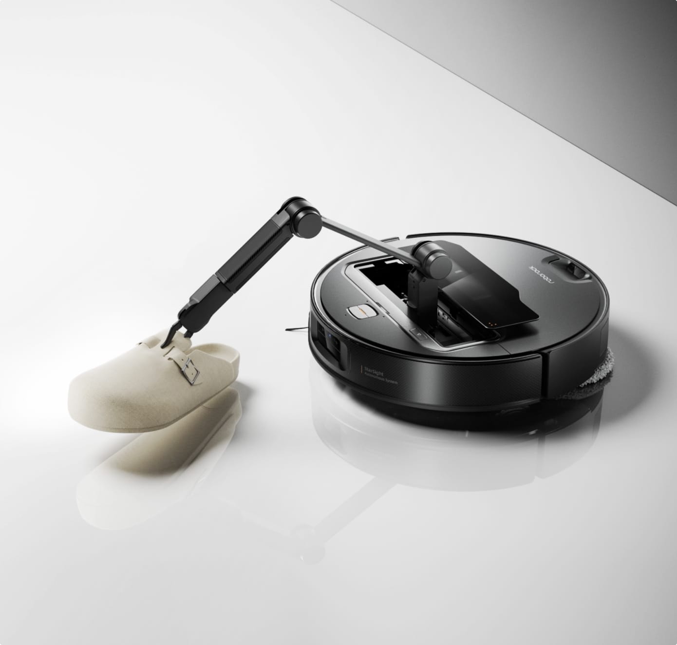 Roborock Saros Z70 mechanical arm lifting a slipper