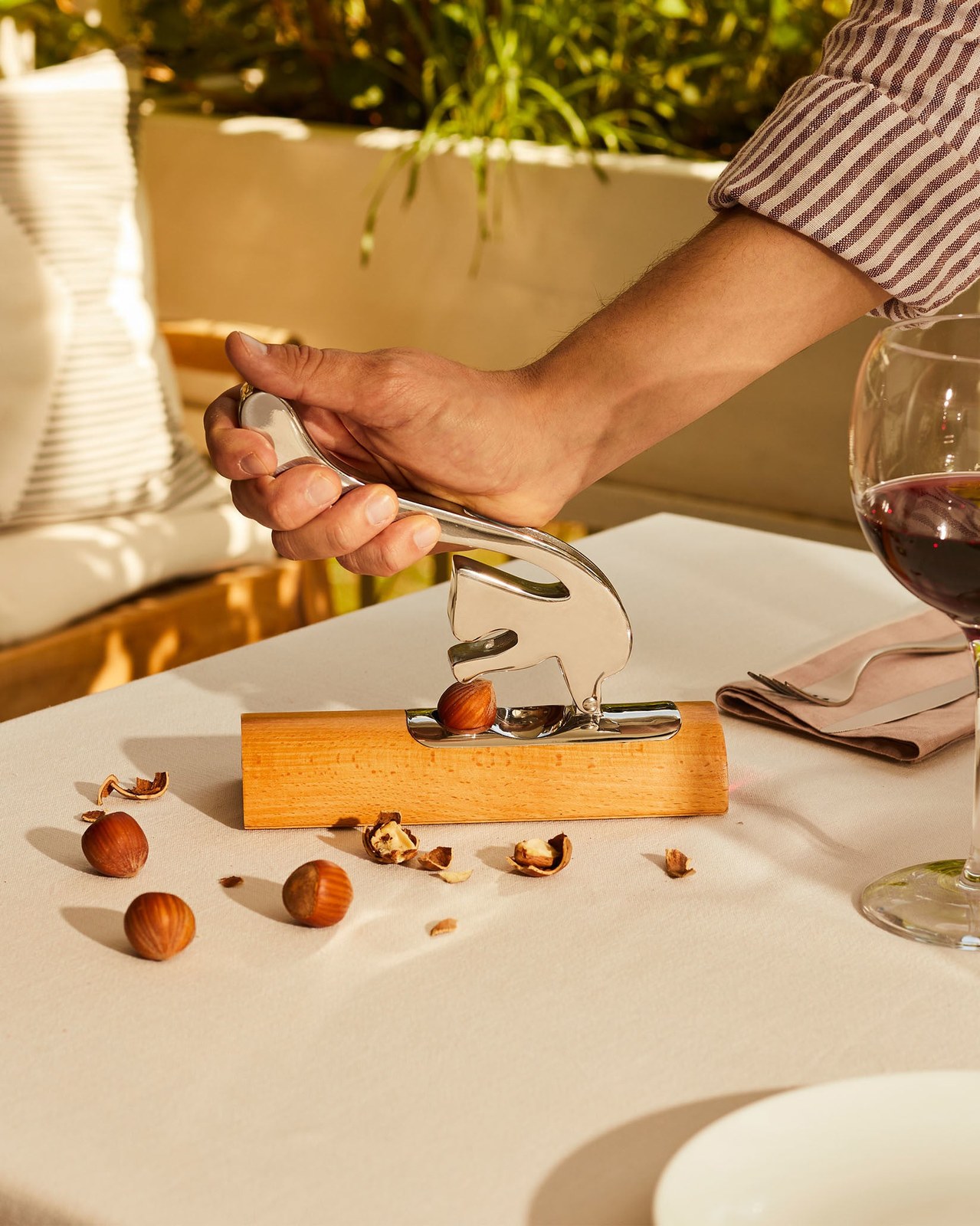 Alessi Scoiattolo nutcracker being used to crack hazelnuts at a table