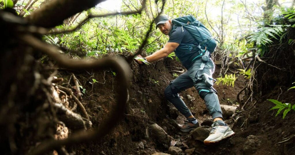 Vastnaut One AI-powered hiking exoskeleton worn on a rugged trail