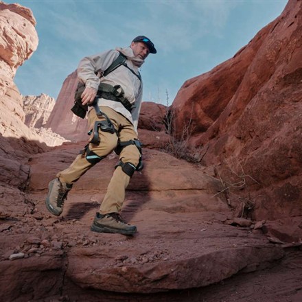 Vastnaut One wearable hiking exoskeleton on red rock trail