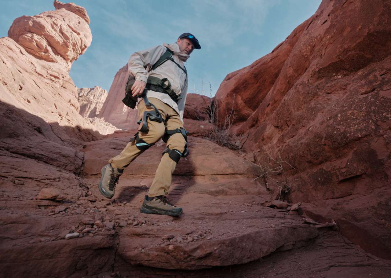 Hiker wearing Vastnaut One exoskeleton on a canyon trail