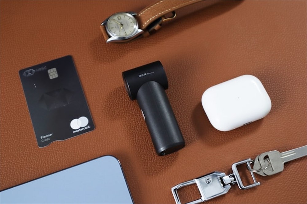 ZERA mini card-sized cooling fan beside everyday carry items for scale