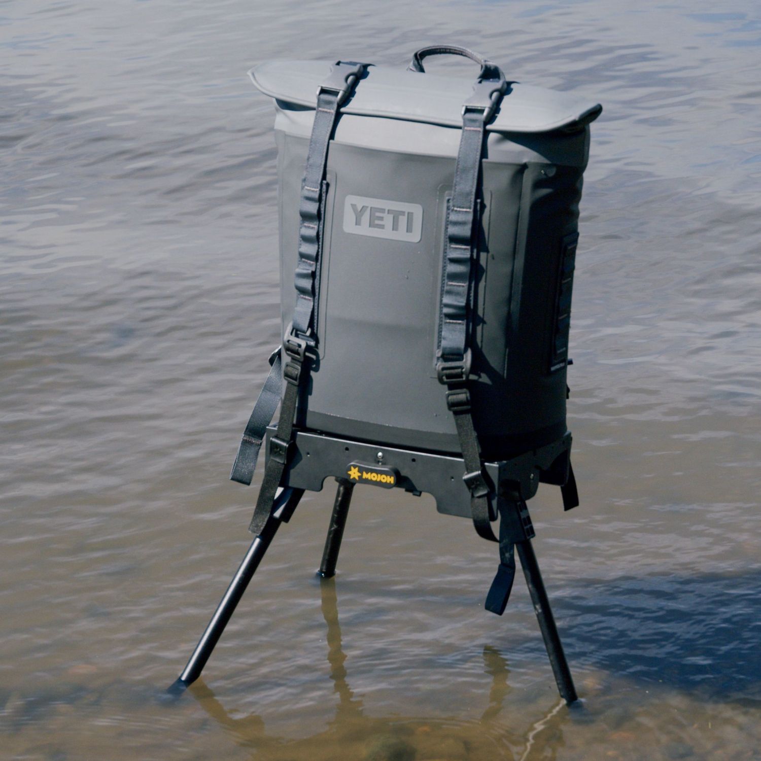 Mojoh Ryzer Go holding a soft cooler bag above shallow water