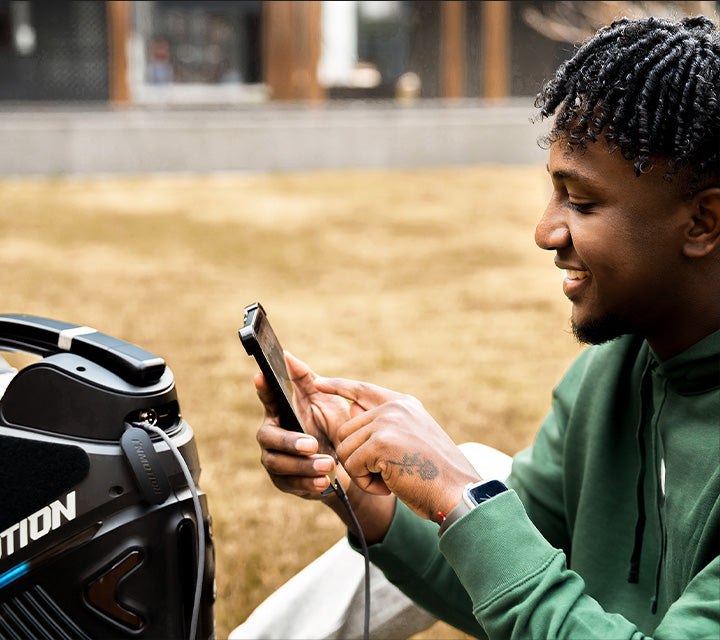 INMOTION V9 rider checking the companion app