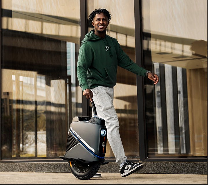 Rider standing beside the INMOTION V9 electric unicycle