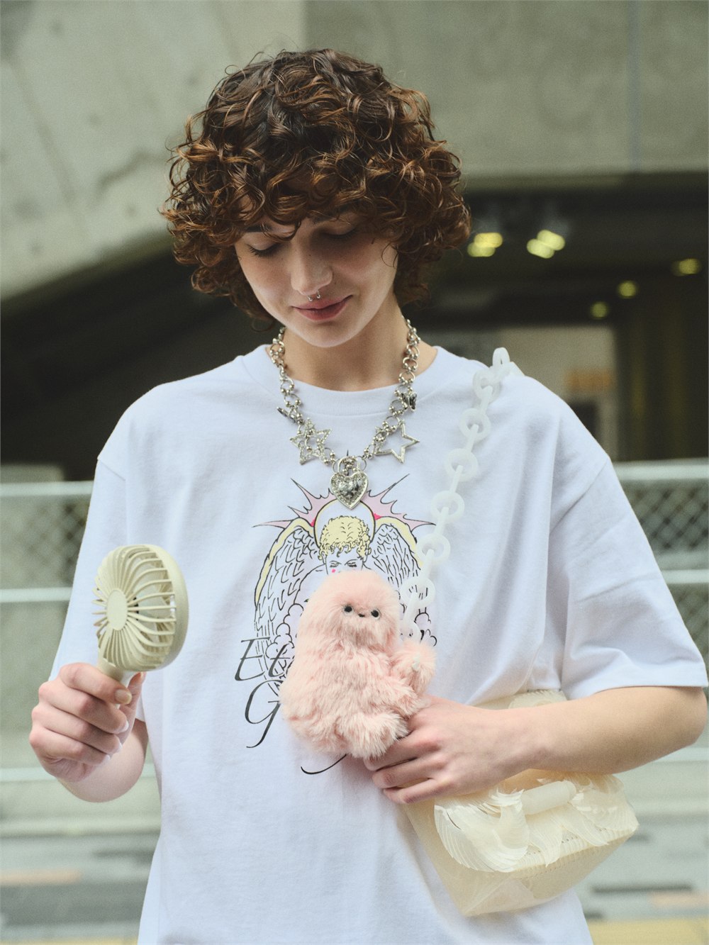 Mirumi bag robot clipped to a brown handbag in an official lifestyle photo