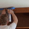 This Hand-Masker Dispenser Lets You Quick Tape and Plastic Wrap Your Furniture In Seconds