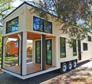 This Farmhouse Style Tiny Home Has Its Own Built-In Porch Area