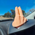 This 2-Finger Waving Hand Mounts To Your Dashboard, Never Miss Another Wave Again