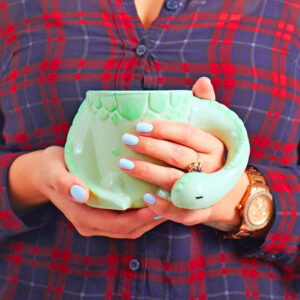 This Sleeping Dinosaur Mug Might Be The Cutest Way To Sip Your Morning Coffee
