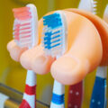 This Foot Toothbrush Holder Holds Toothbrushes or Cords Between The Toes