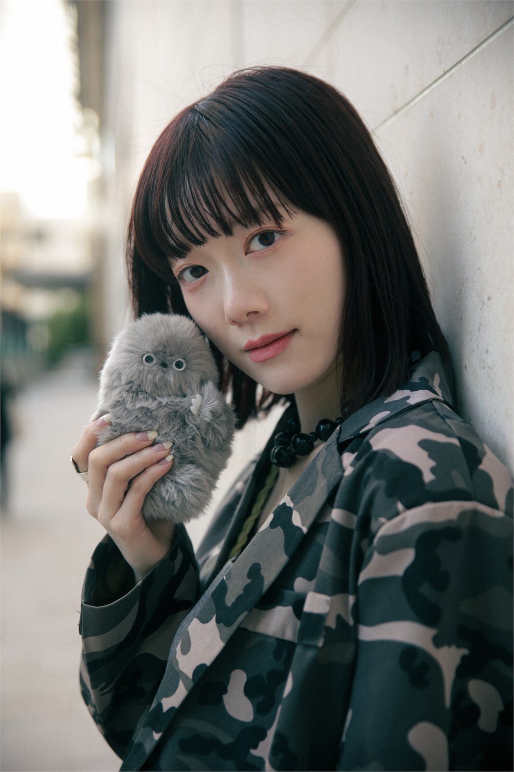 Mirumi perched on a bag in a clean studio product shot