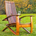 This Adirondack Chair Is Made From an Old Wine Barrel and Has a Slot For a Wine Glass