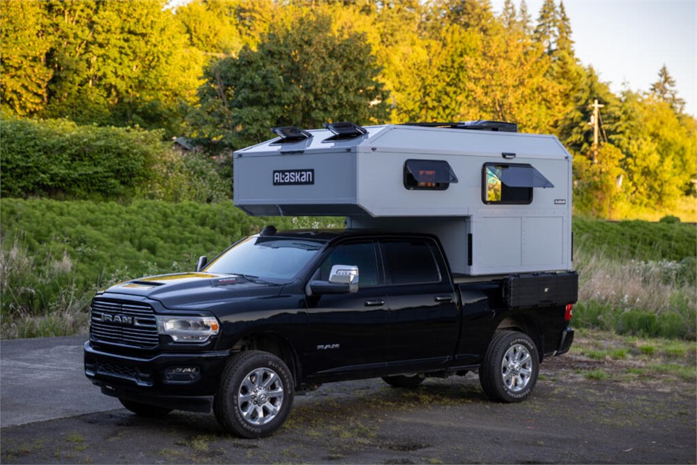 Alaskan HS 640 truck camper shown from the side on a black pickup