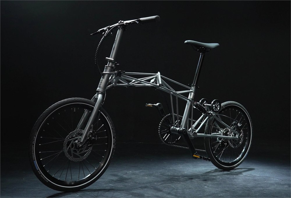 Tetra folding bike shown from the side with its long tubular space frame