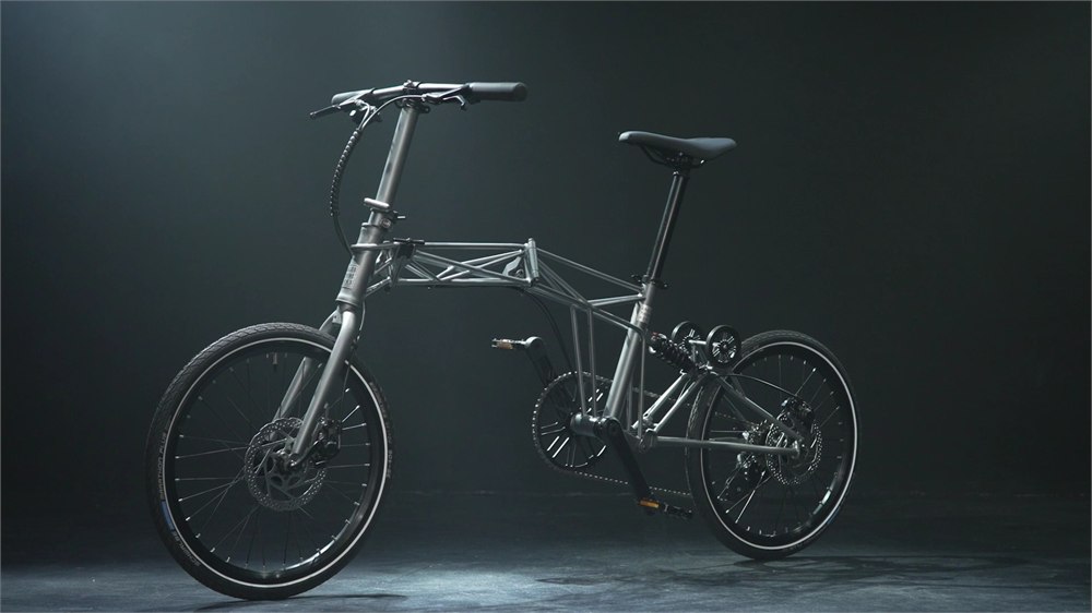 Tetra folding bicycle standing in a dark studio profile view