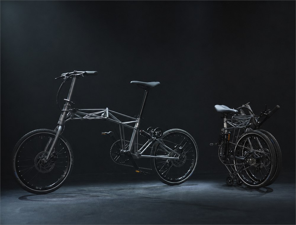 Tetra bicycle shown next to its folded rolling form