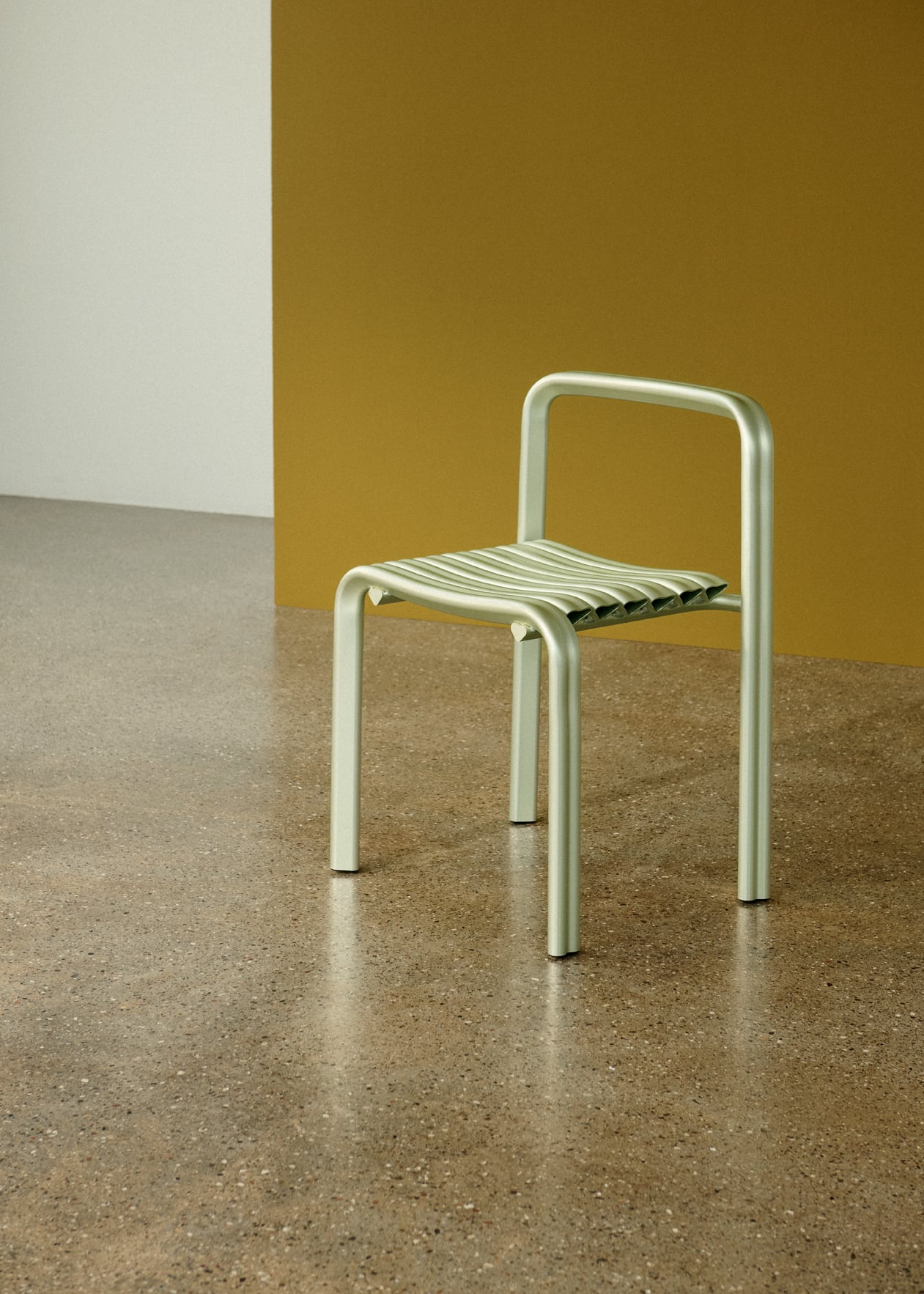 Close to Heart aluminum chair displayed in a modern interior setting