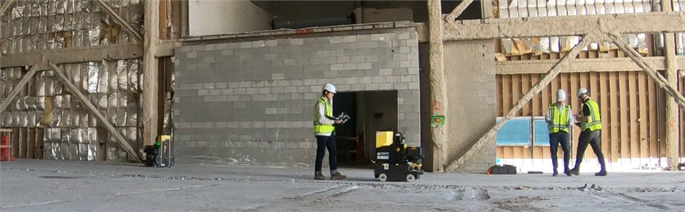 DALE autonomous drilling robot working on a construction site with operators nearby