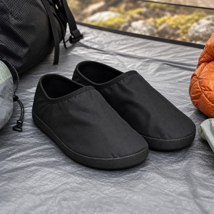 Square thumbnail of ultralight black camp shoes on a tent floor